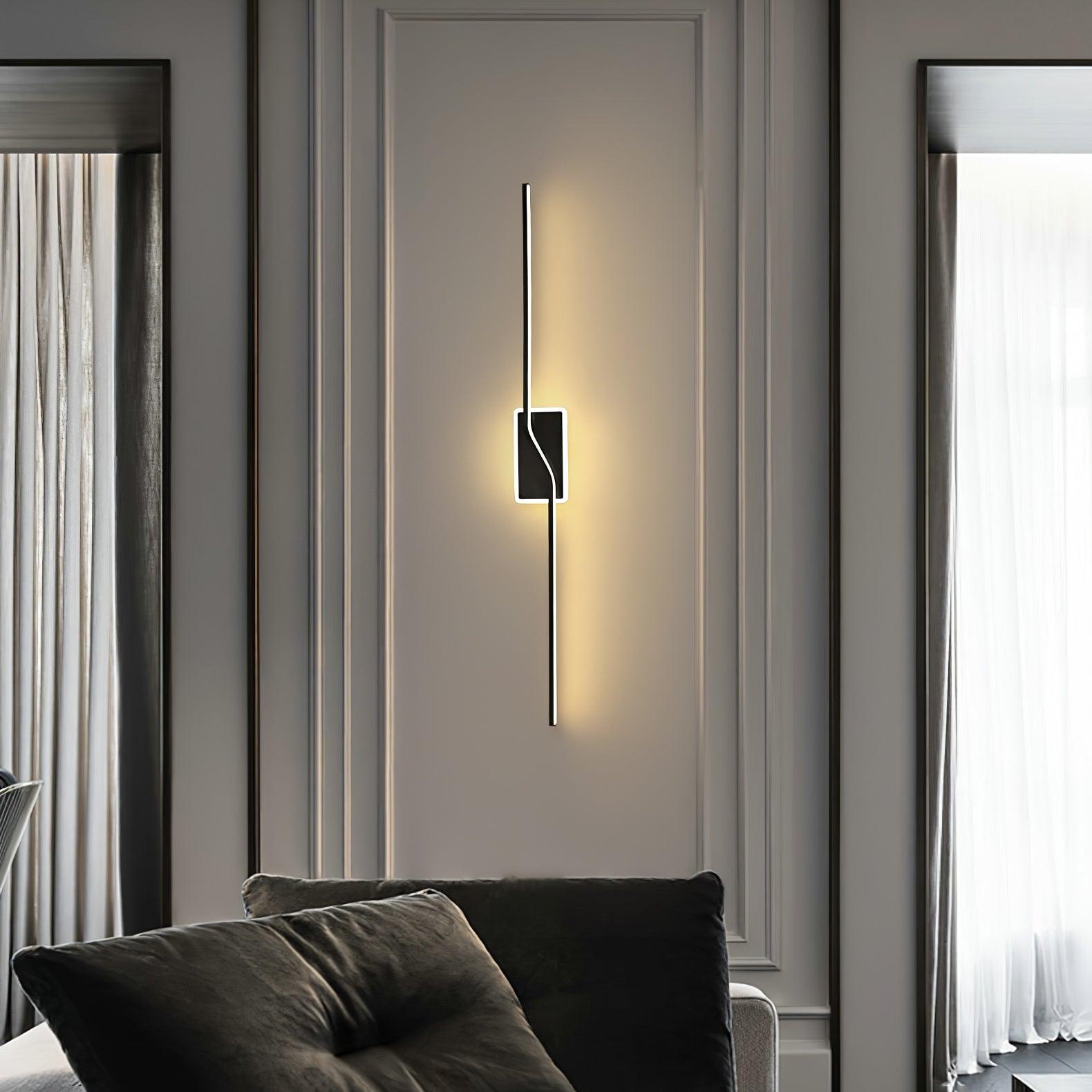 Black linear wall light near a sofa