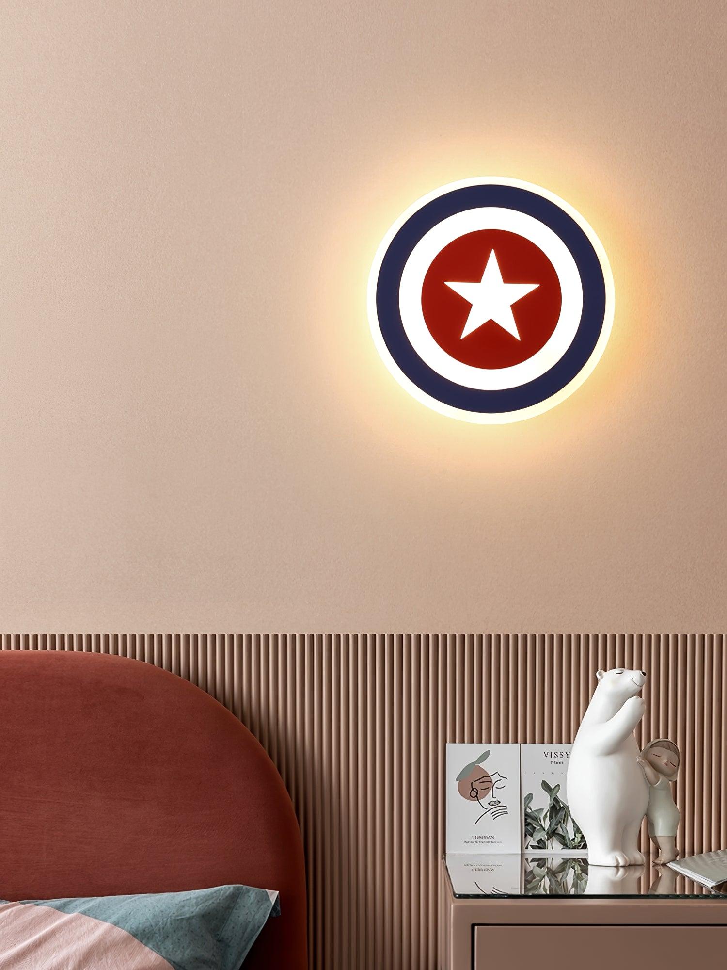 Lit star wall lamp above ribbed beige panels, rust bedhead and bear-and-person ornaments