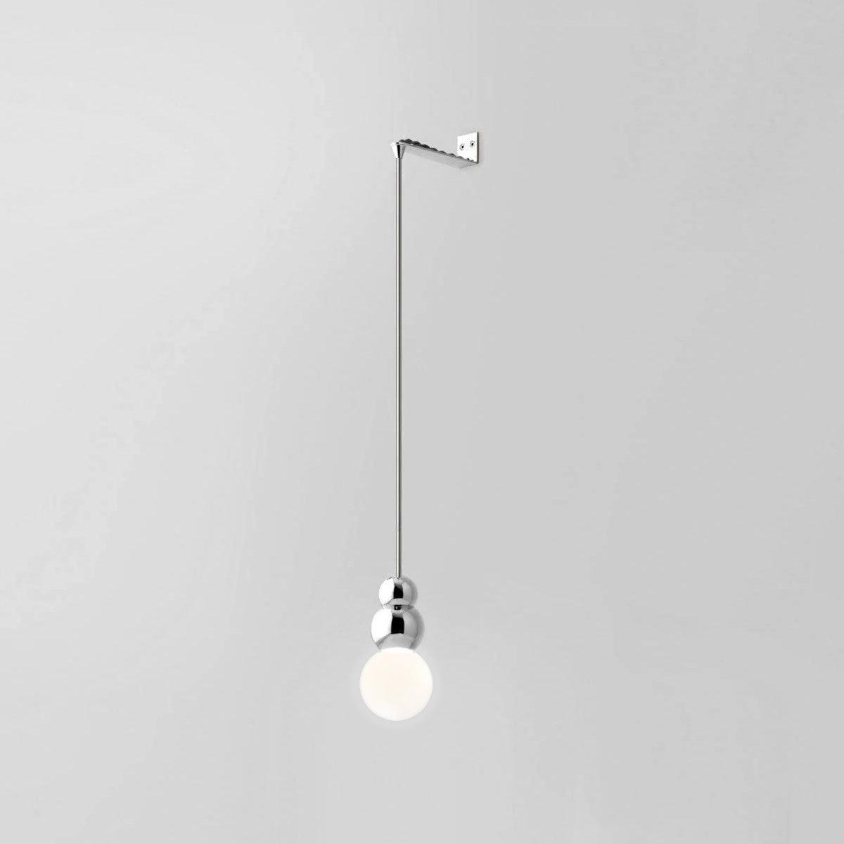 Large white globe beneath chrome rounded sections on a suspension rod