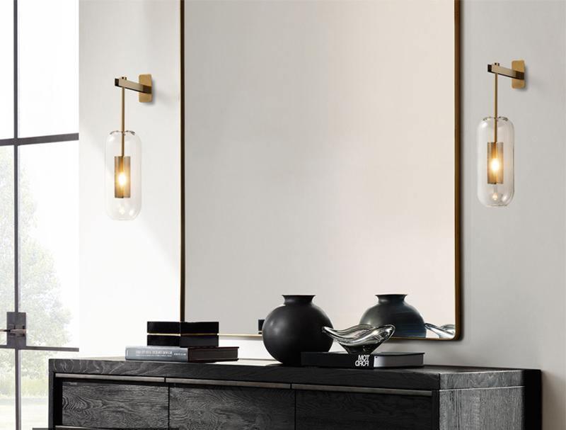 Two glass wall fixtures above a console