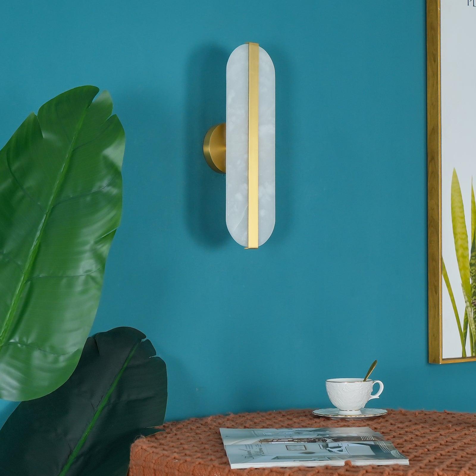 Vertical White sconce beside a plant