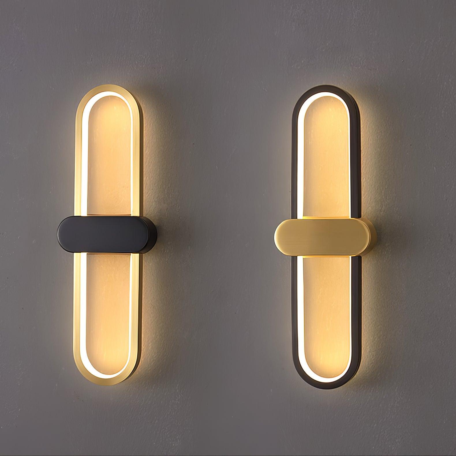 Side-by-side comparison of gold-loop black-centre and black-loop gold-centre oval wall lights