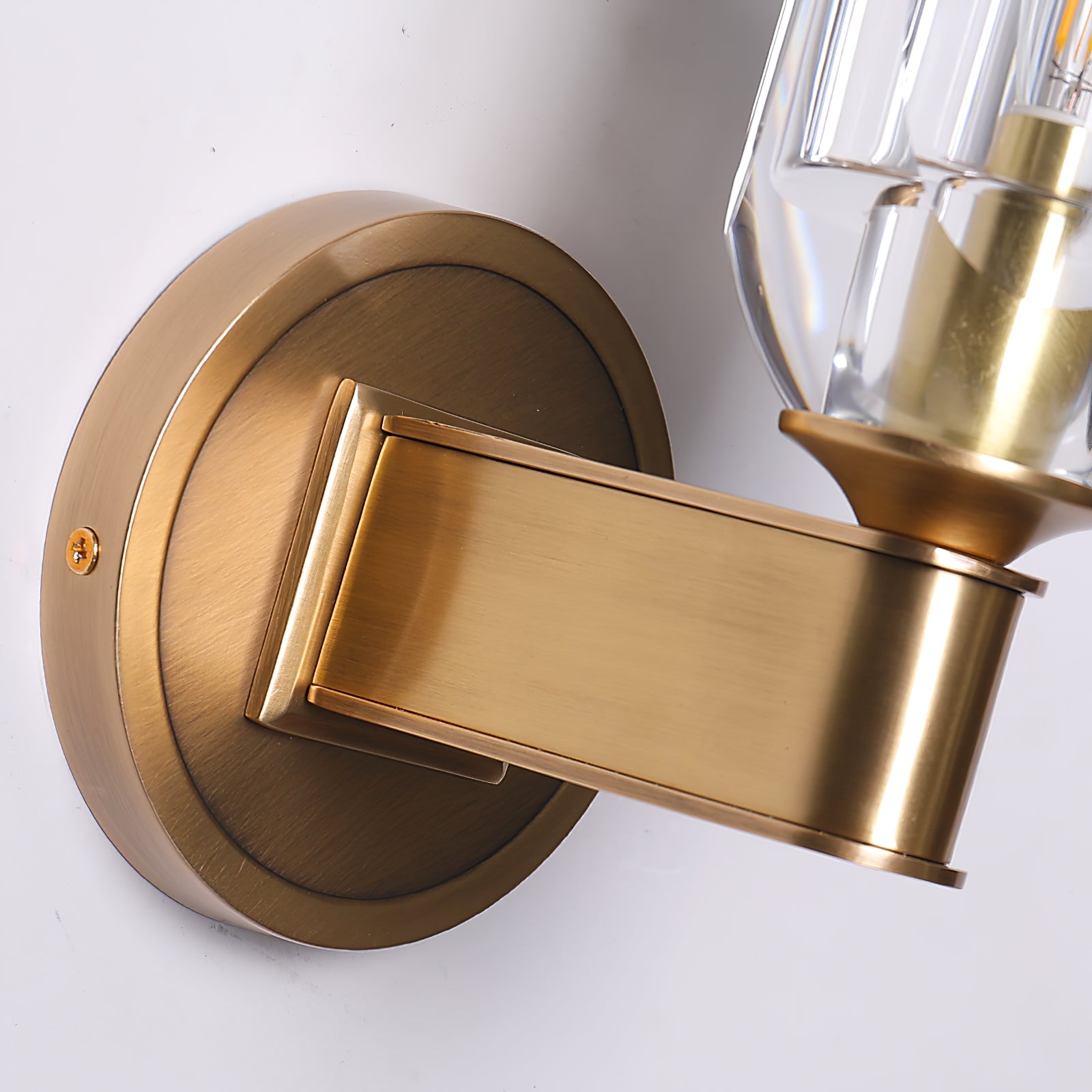 Close-up of broad curved metal arm and stepped wall plate