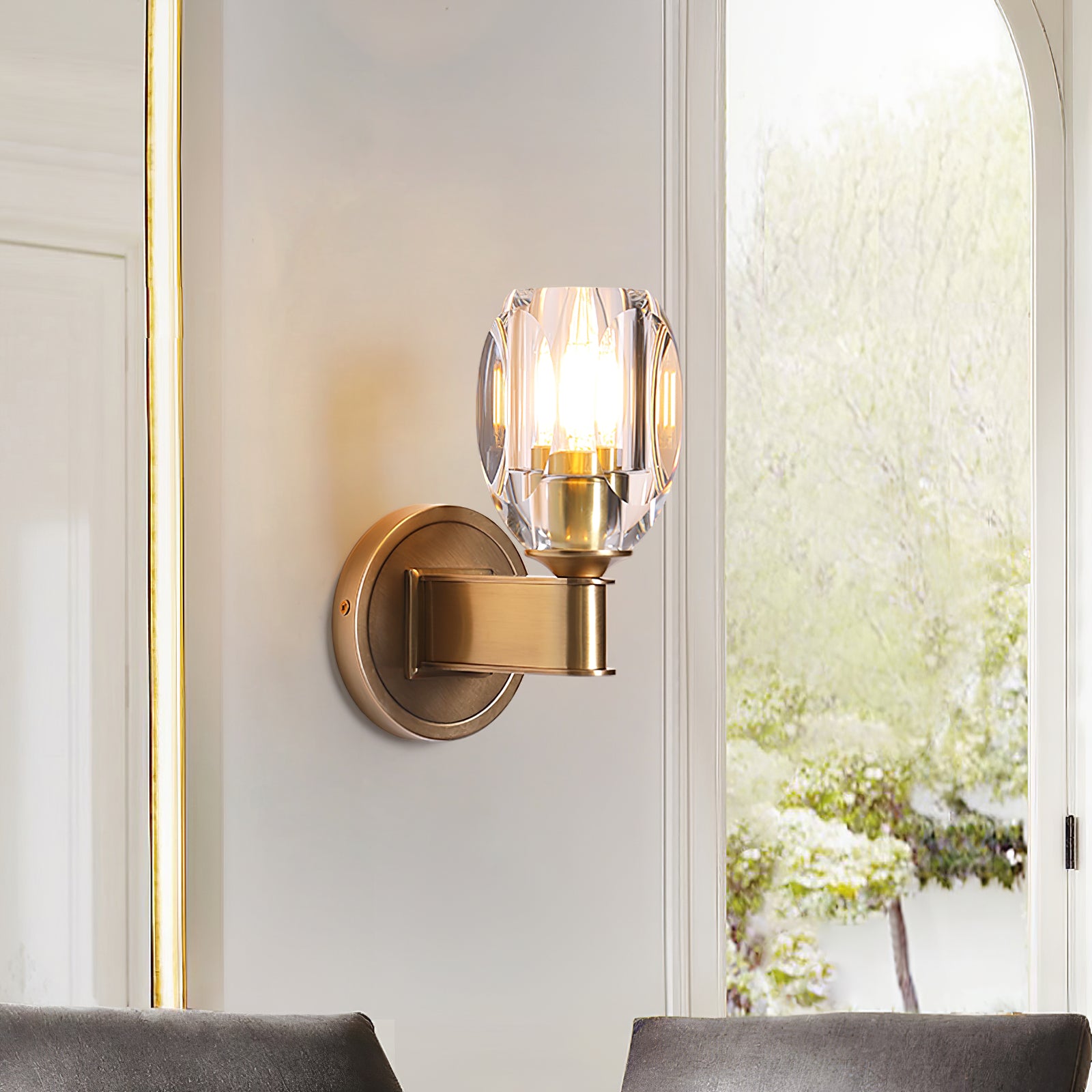 Lit crystal sconce beside a window