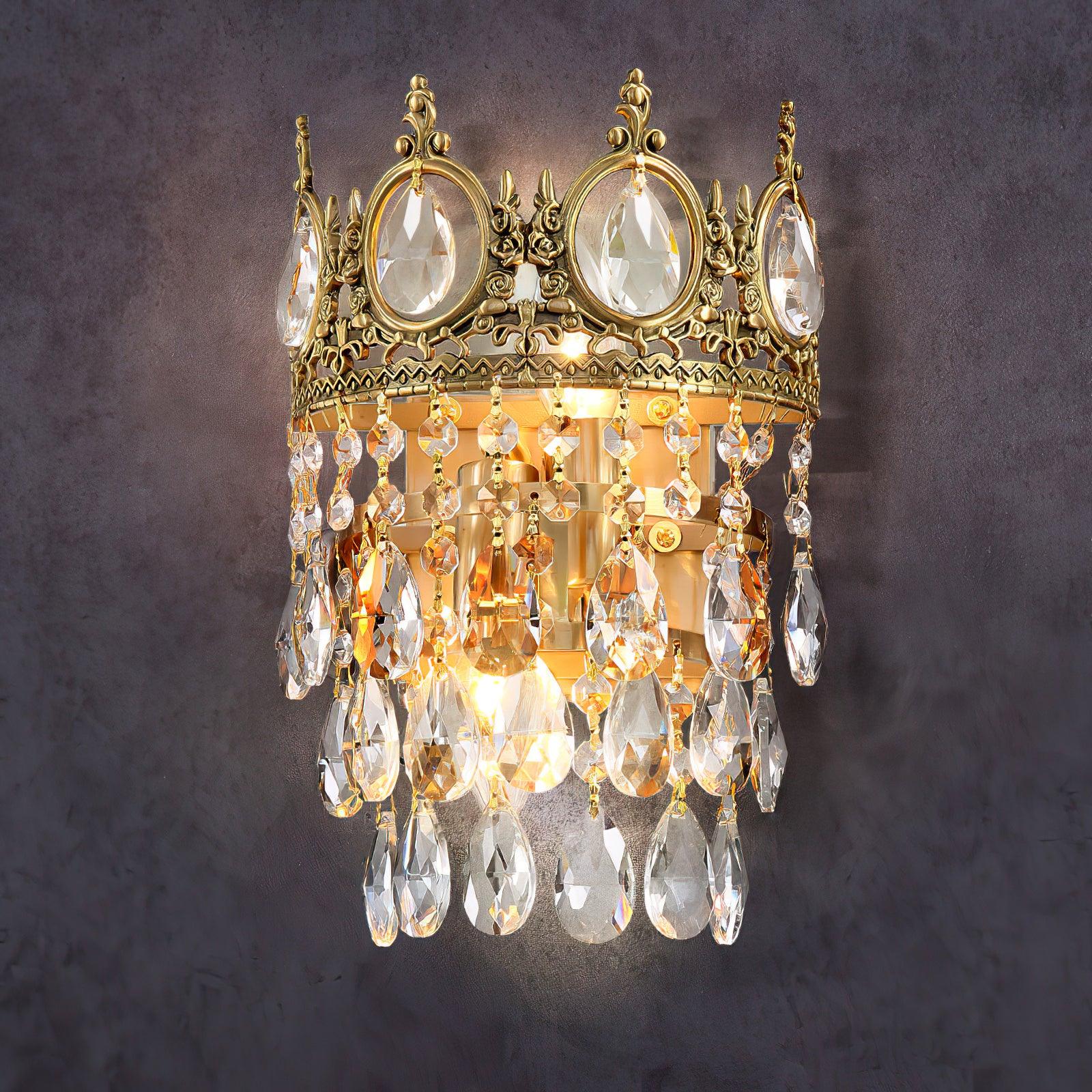 Lit tiered crystal sconce against a dark background