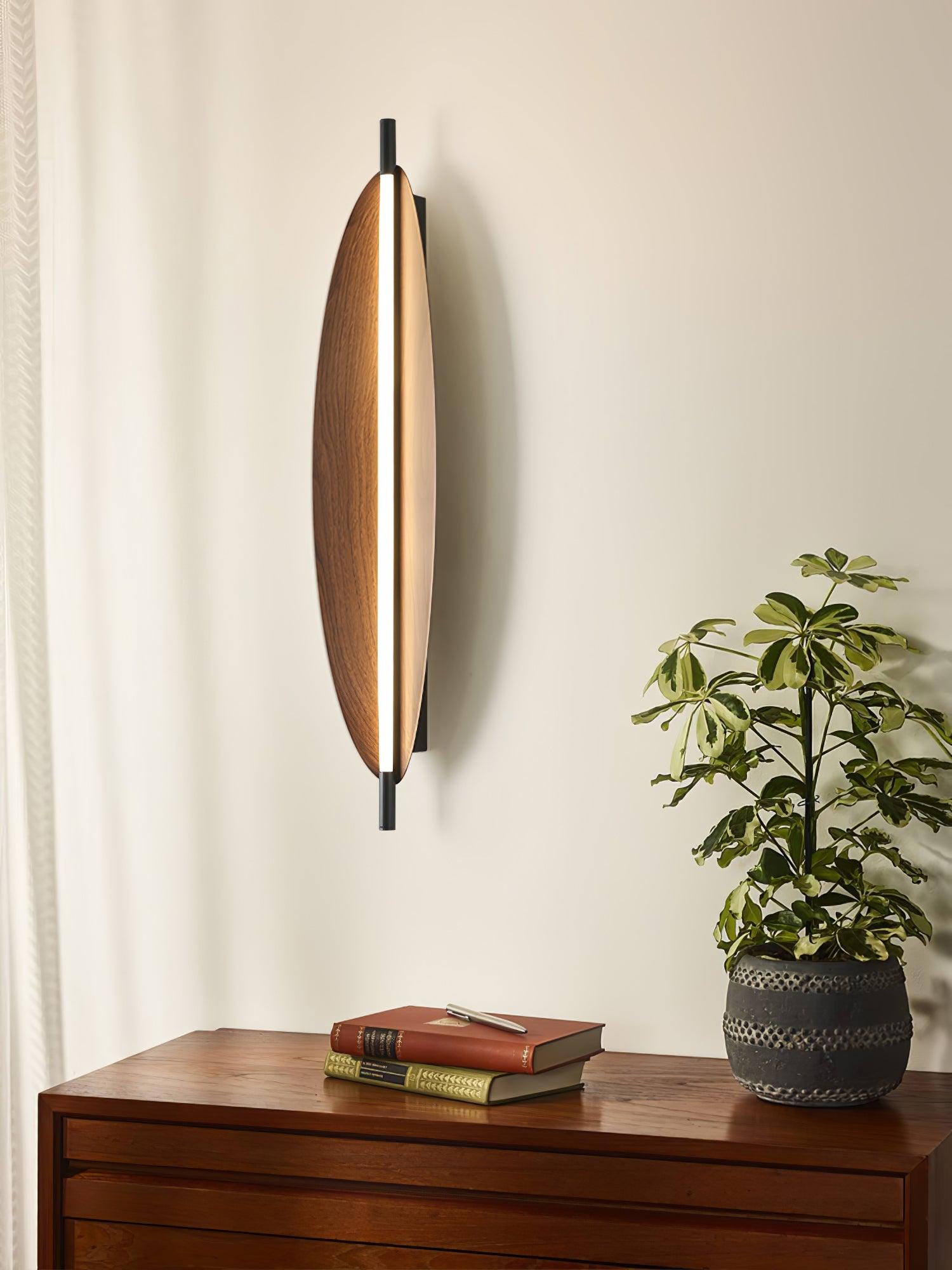 Sleek Board wall sconce with an oval woodgrain-look face and central light strip