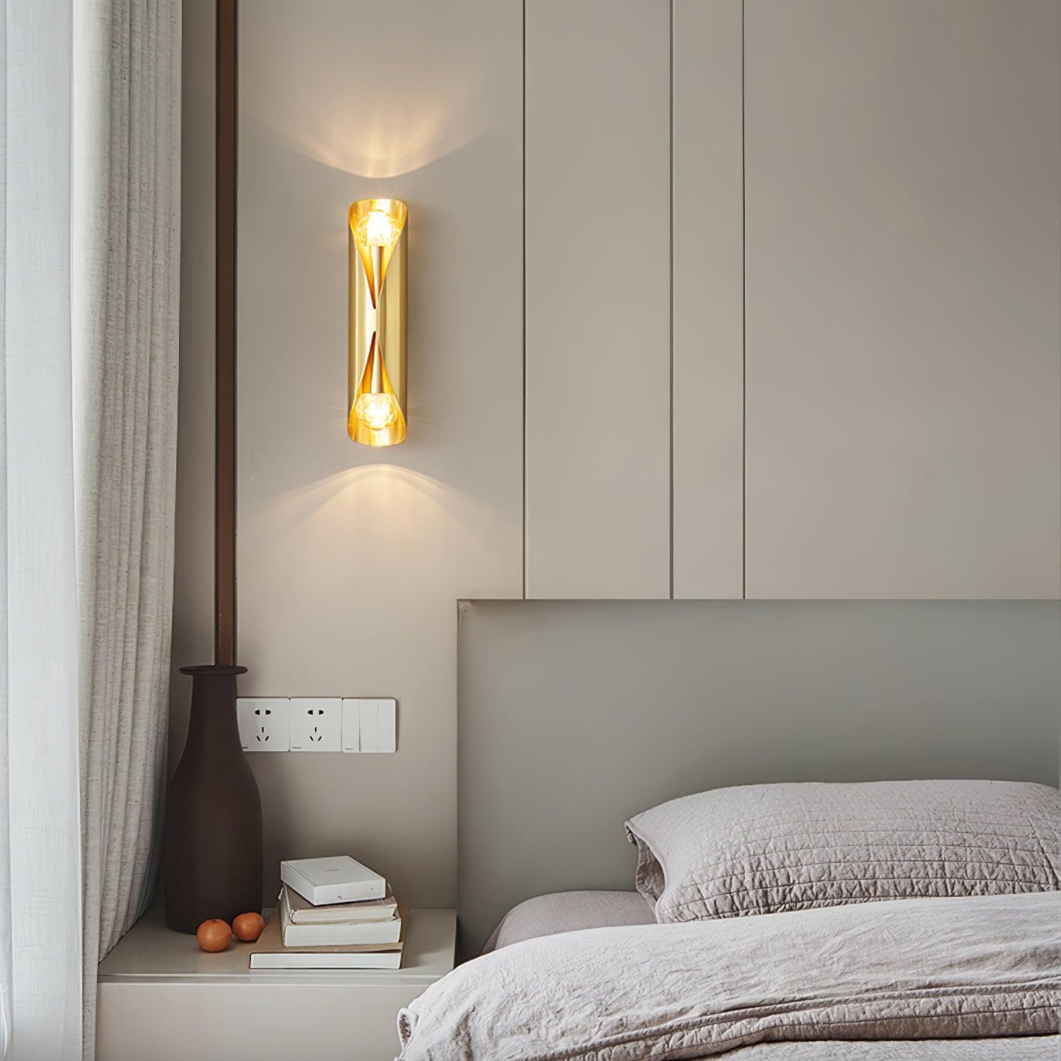 Brass slim wall lamp beside a bed