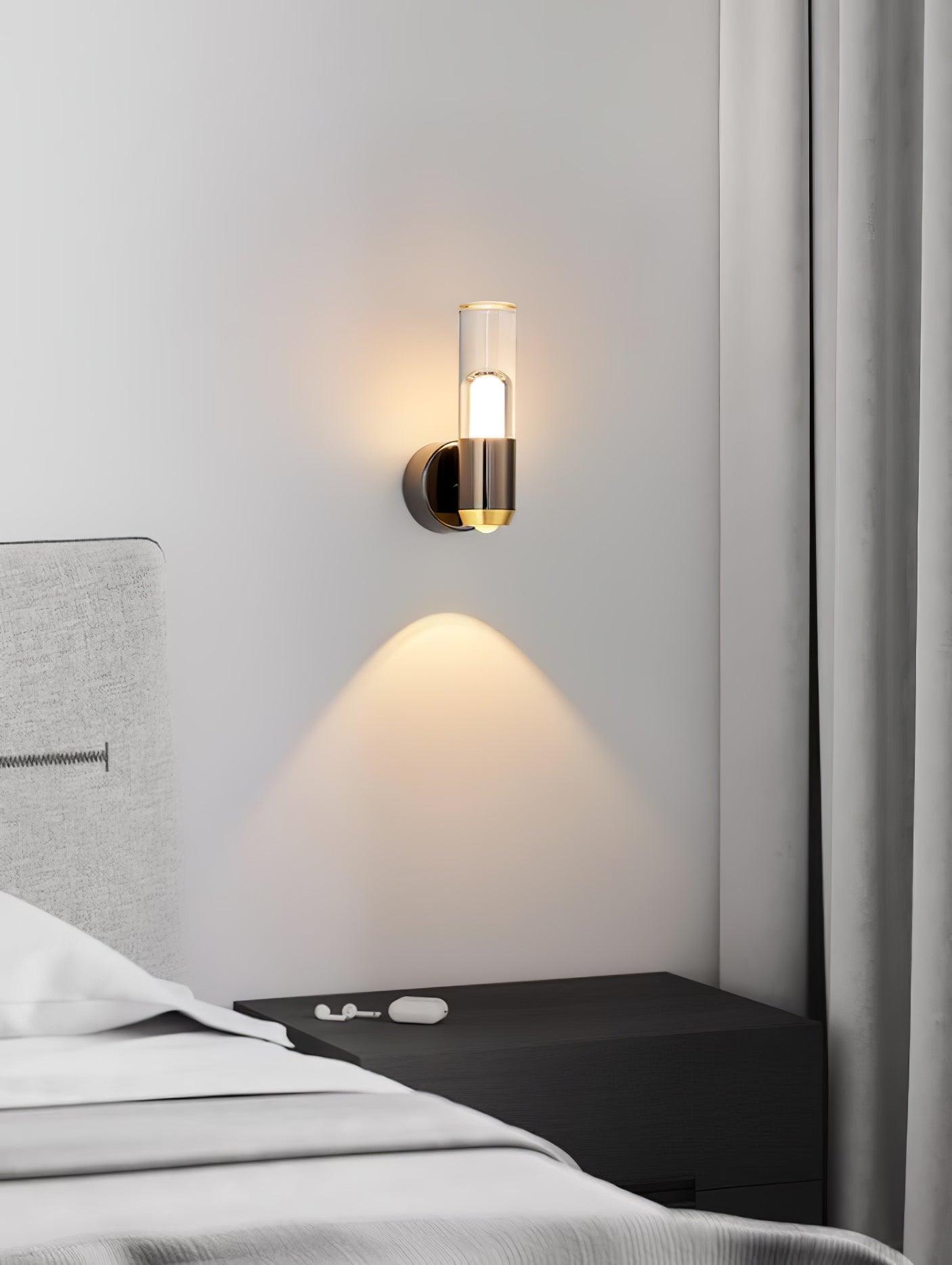 Cylindrical Modern wall light with a clear cylinder and metal fittings
