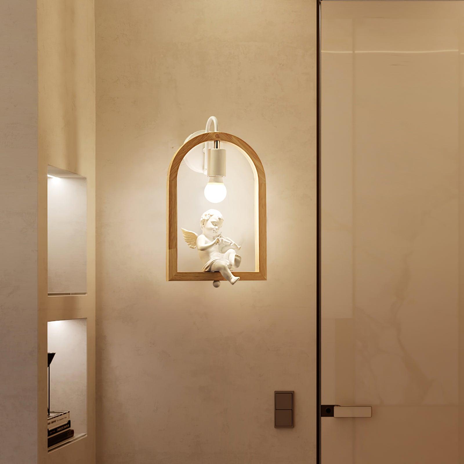 Cherub wall light beside a glass door and recessed shelves, with an illuminated bulb above the violin-playing figurine