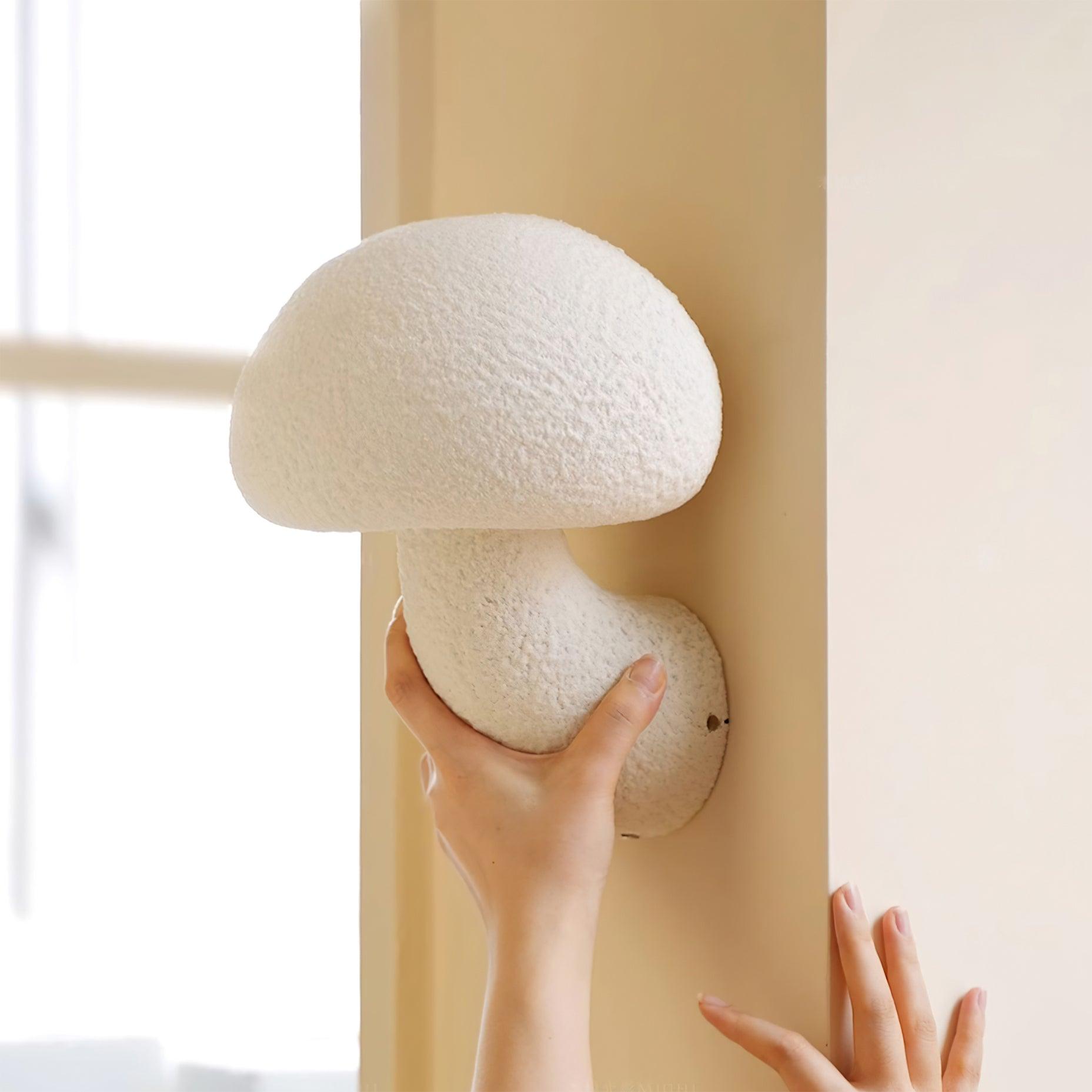 Hand beside a textured White mushroom wall lamp