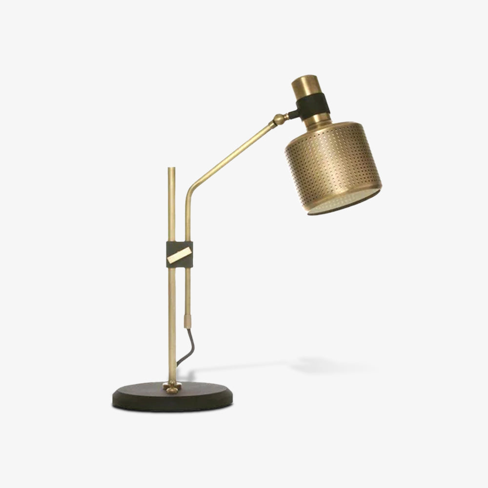 Opposite-angle view of a gold-and-black single-head lamp with the perforated shade facing right above a black round base
