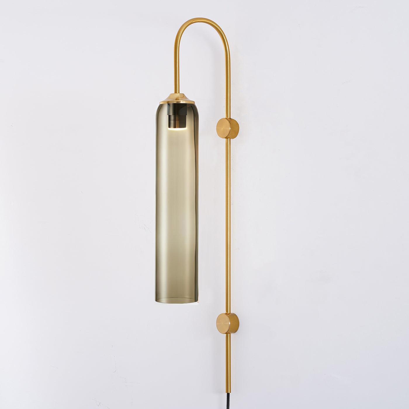 Gold-toned reflective shade and slim wall stem