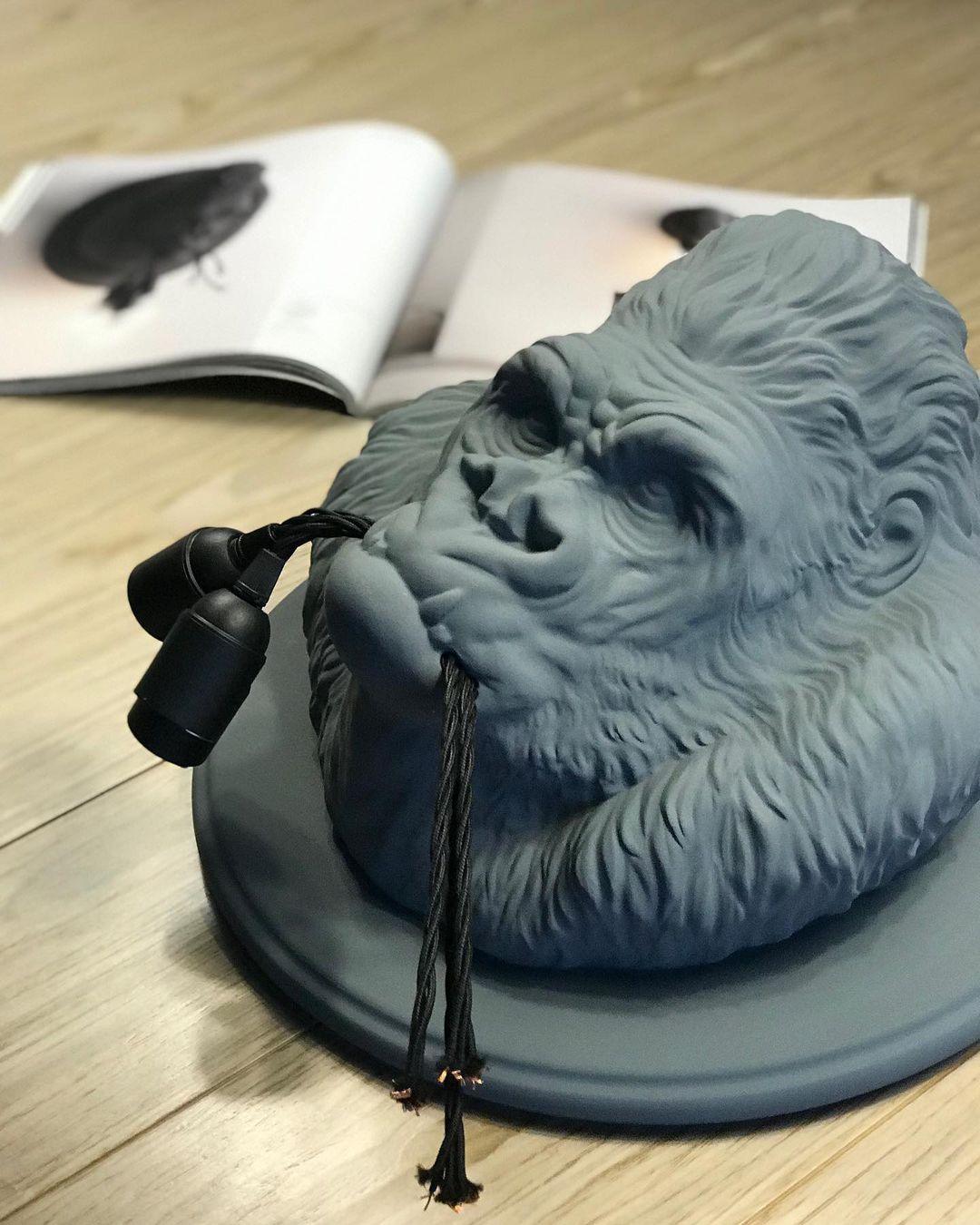 Angled grey gorilla sculpture on a table