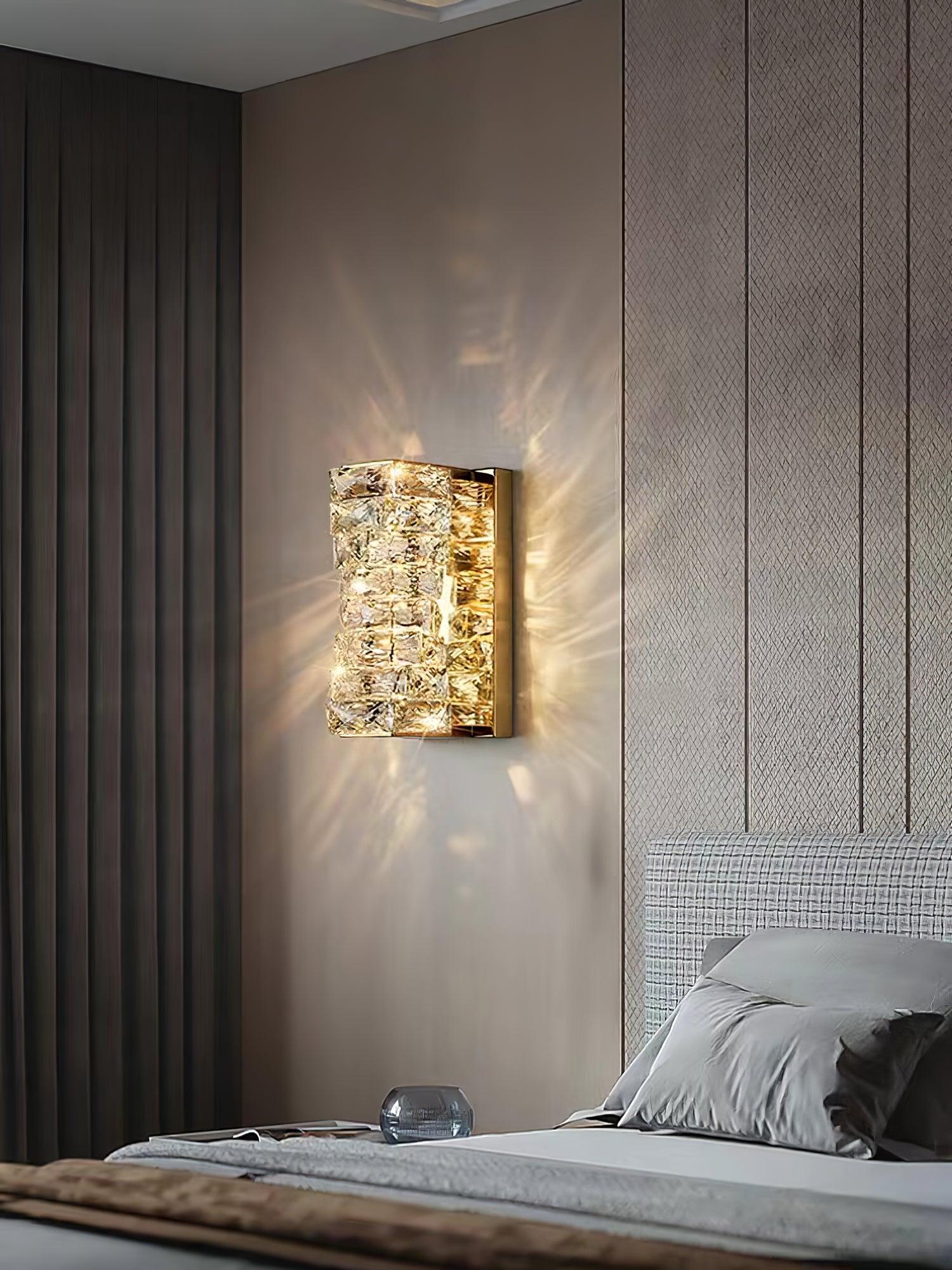 Short Gold crystal fixture beside a headboard