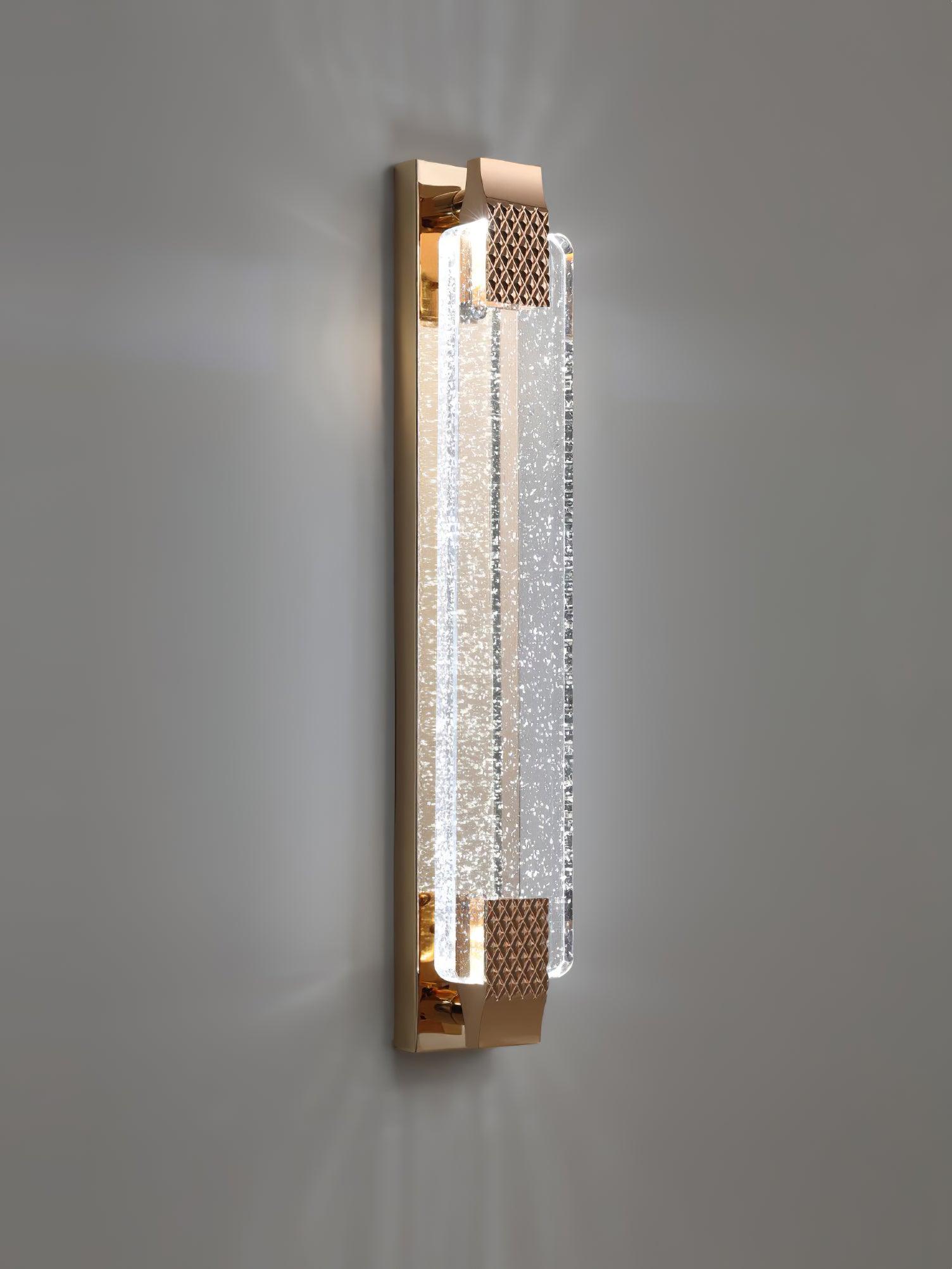 Portrait of a white-glowing Moet sconce against gray, with bubbles visible through the clear panel