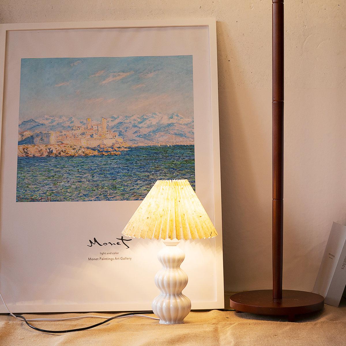 Leo patterned shade illuminated in front of framed art