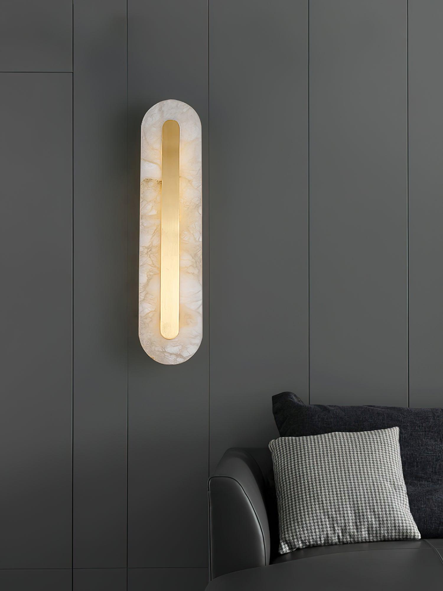 Vertical alabaster light beside cushions