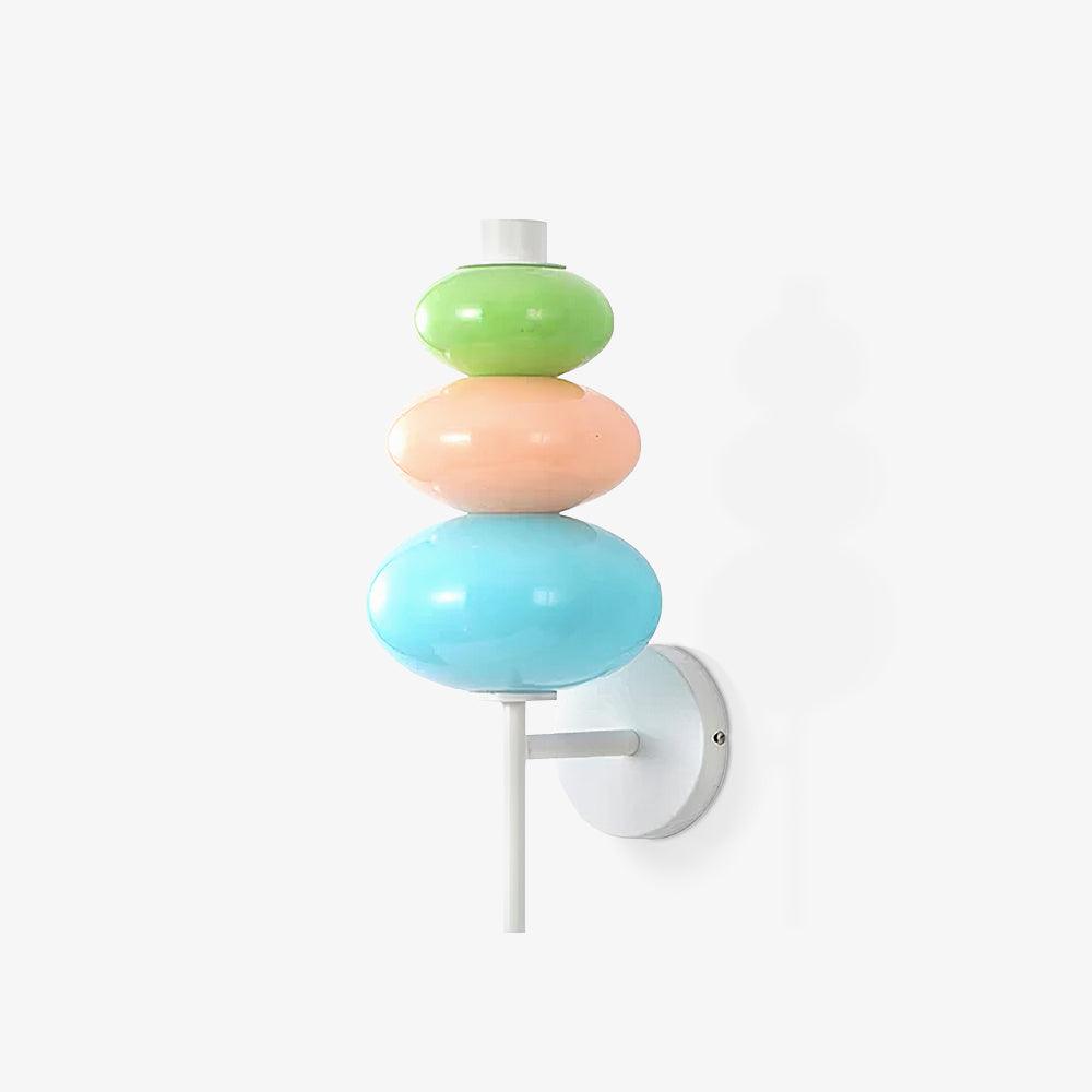 Farther isolated view of the unlit three-color glass wall light and white mounting support