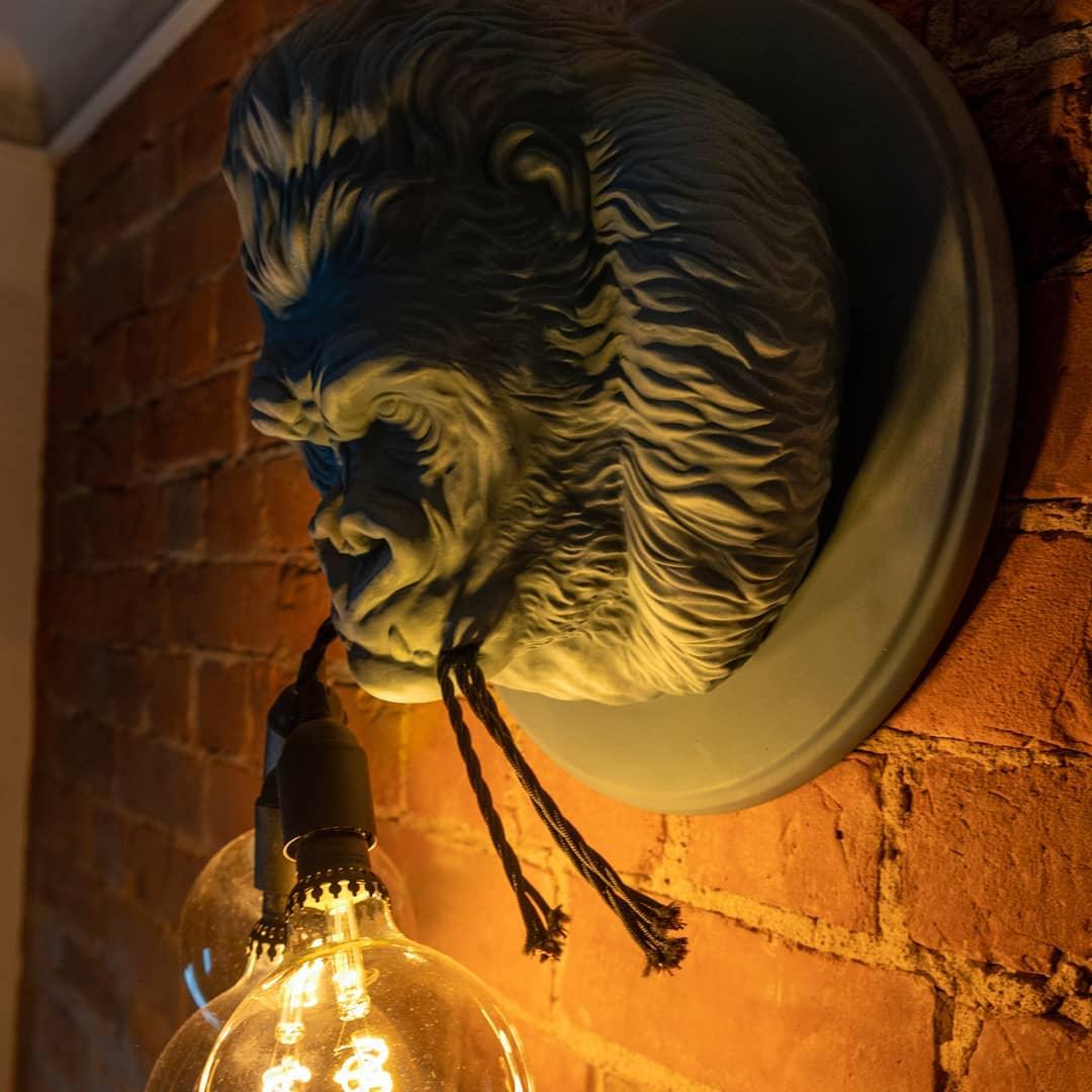 Gorilla wall light against exposed brick