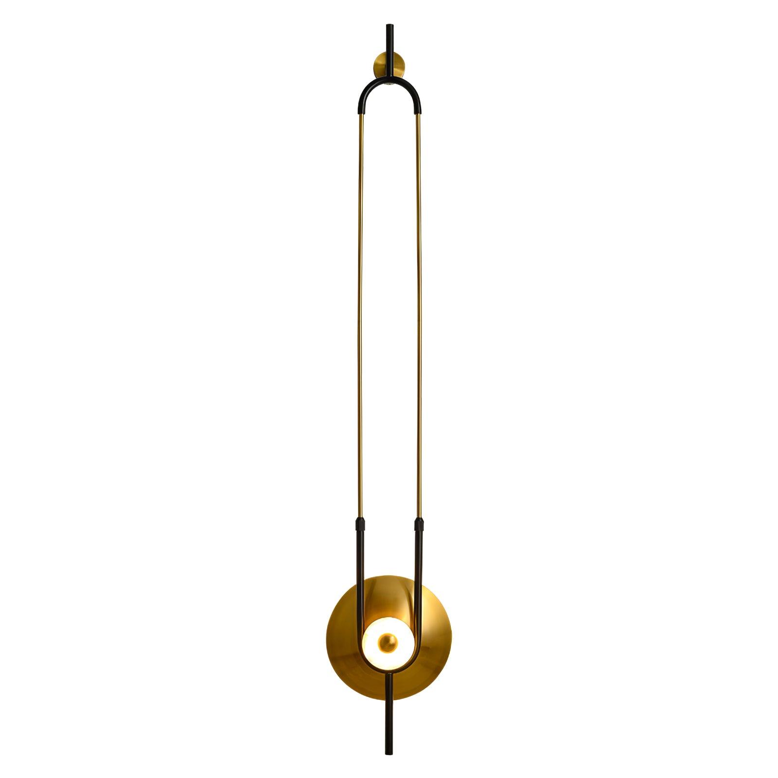 White-background portrait of tall open-loop wall light with gold rods, black curved ends and lit white ring