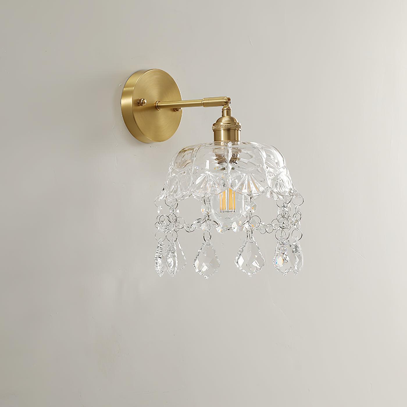 Unlit bell-and-drop wall light with a visible filament-style bulb and gold-tone fittings