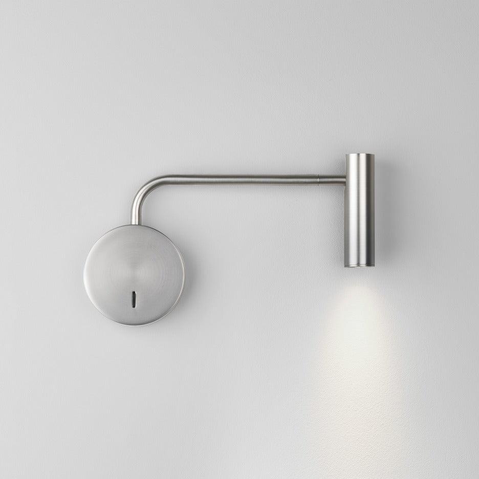 Brushed nickel-coloured wall light with circular plate and slim cylindrical downlight