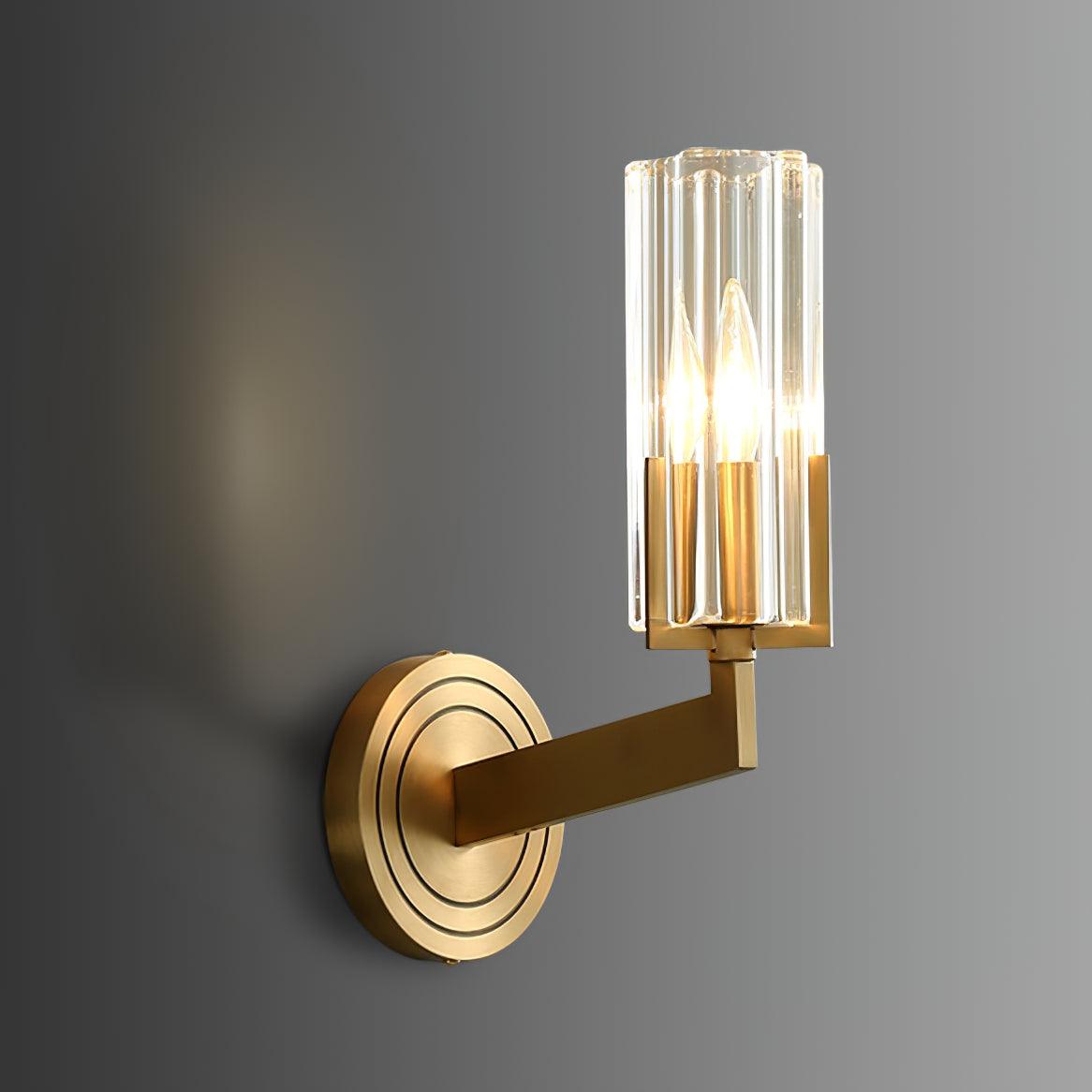Narrow Kayla option with lit single clear fluted shade, brass right-angle arm and concentric-ring wall plate on grey background