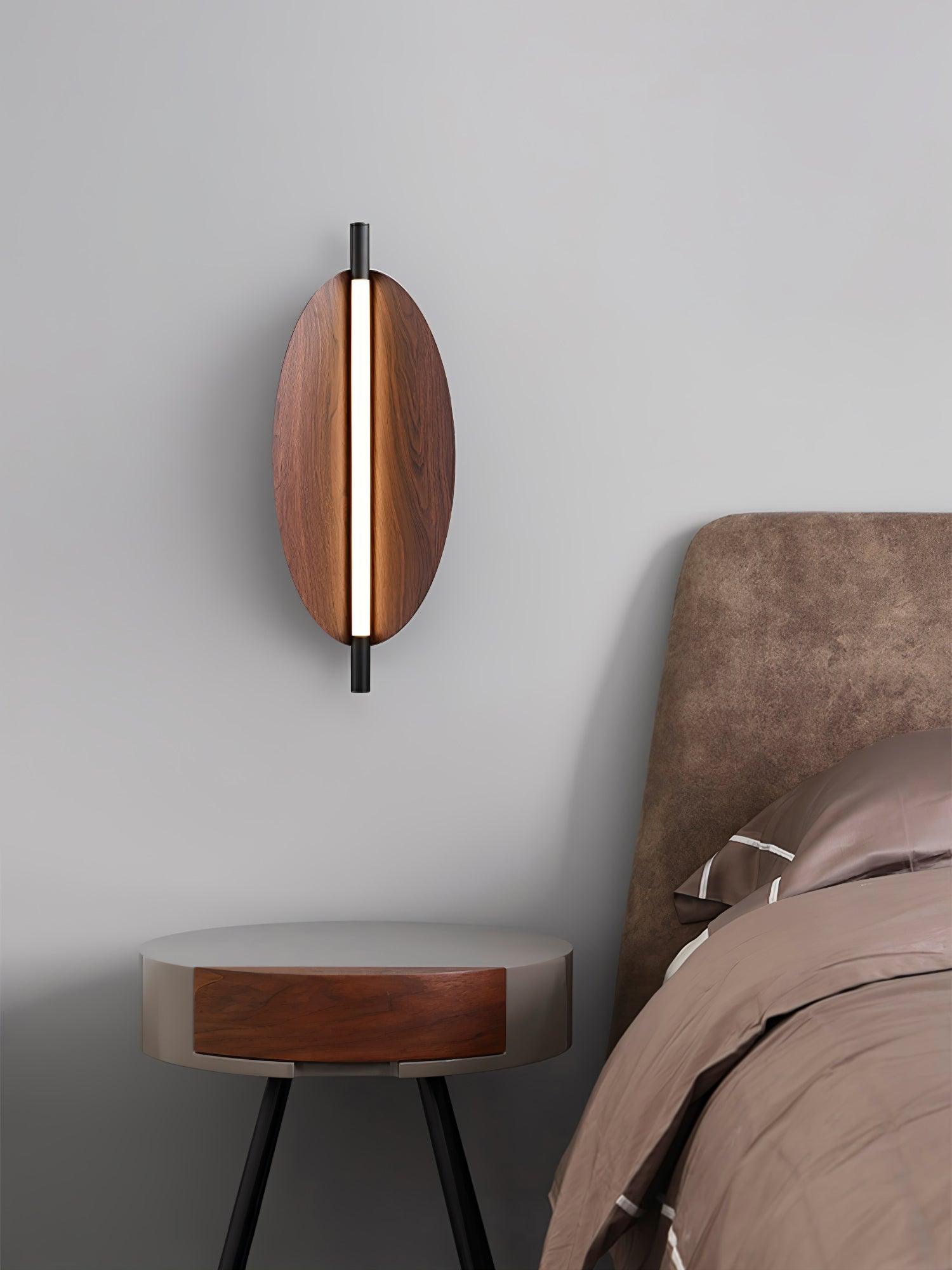 Sleek Board wall sconce with an oval woodgrain-look face and central light strip