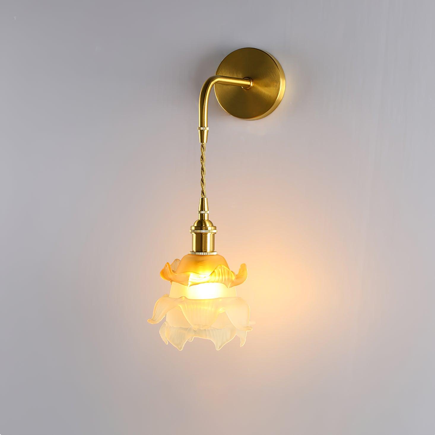 Laura brass wall lamp with a hanging white and orange flower-like shade