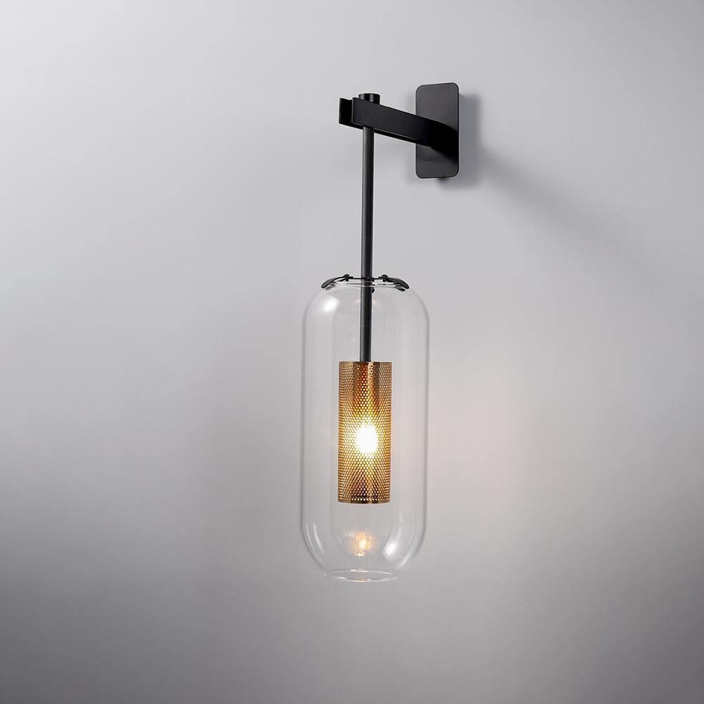 Black Vadim wall arm suspending a clear glass shade and gold-coloured inner cylinder