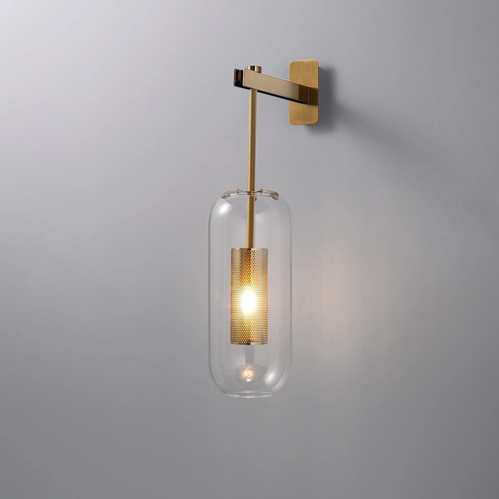 Gold-coloured Vadim wall light with clear glass and a perforated inner cylinder