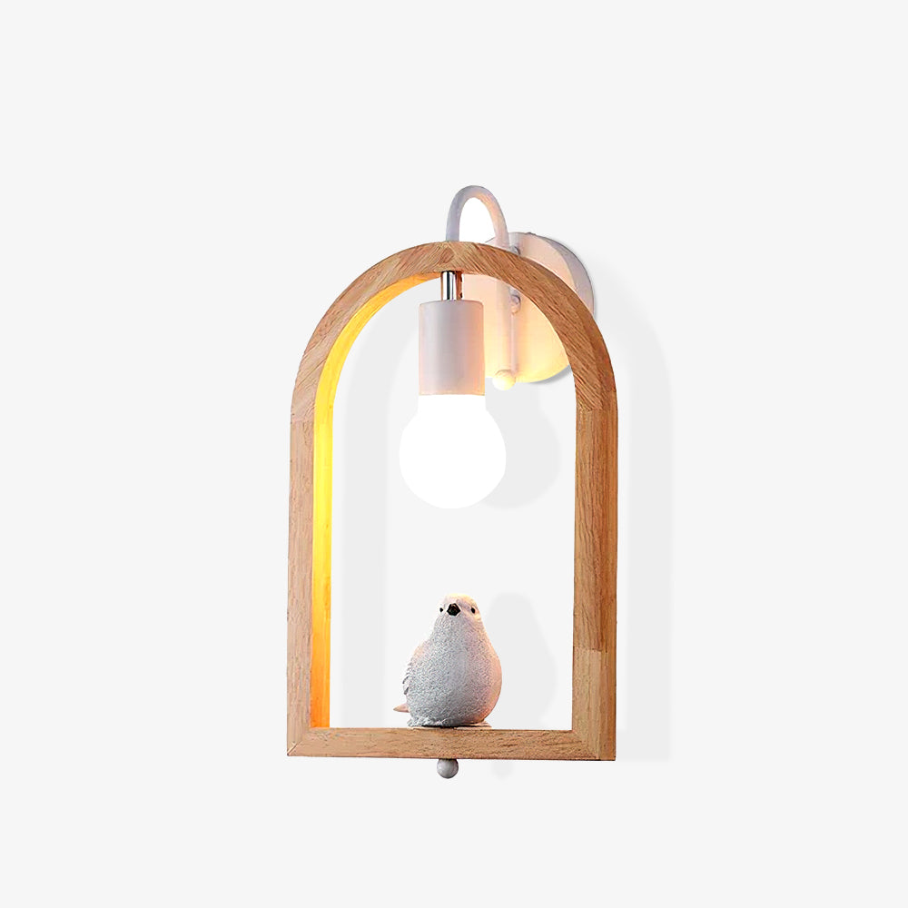 Opposite angled view of the bird wall light on white, with wood-grain arch, exposed bulb and round white wallplate