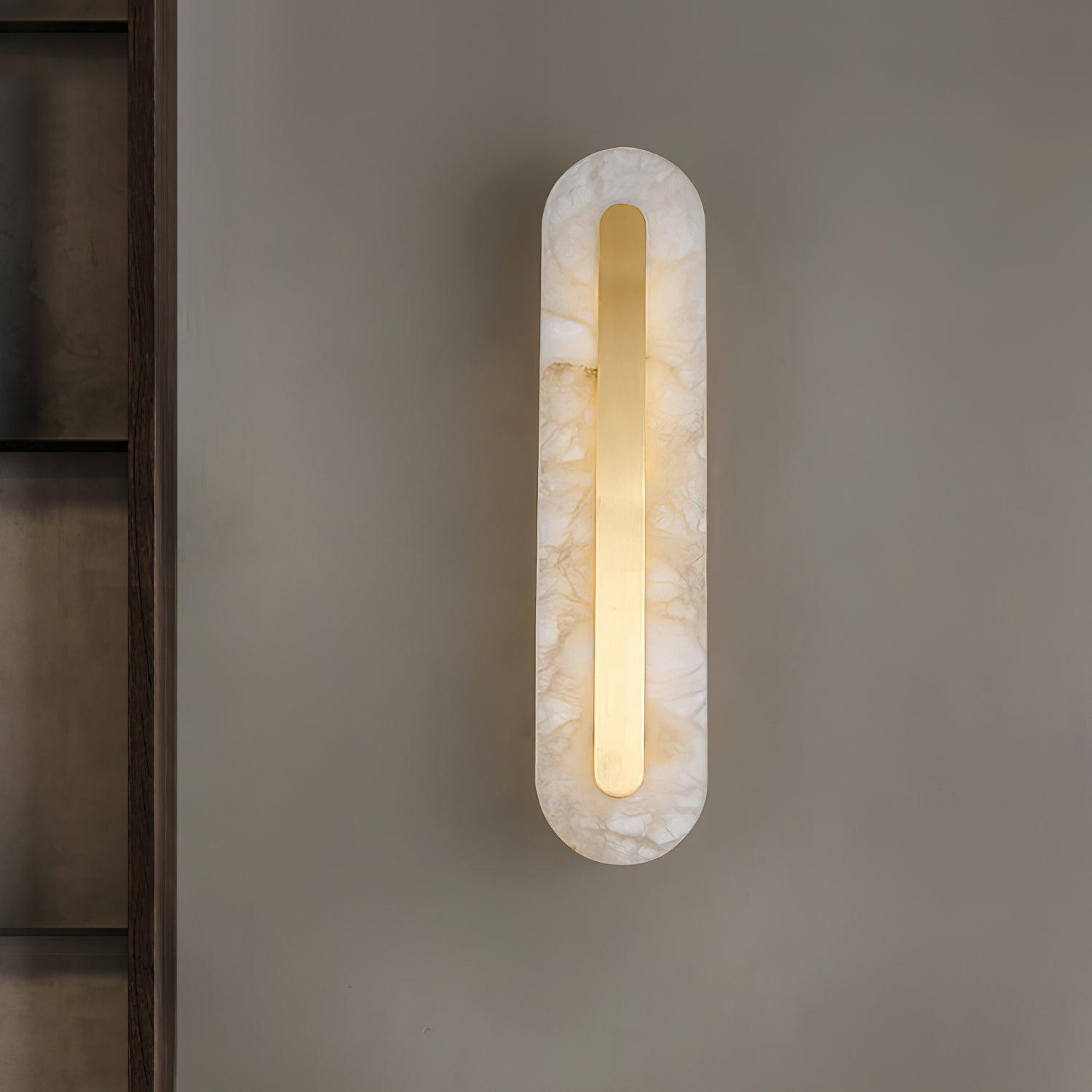 Rounded stone panel illuminated on a pale wall