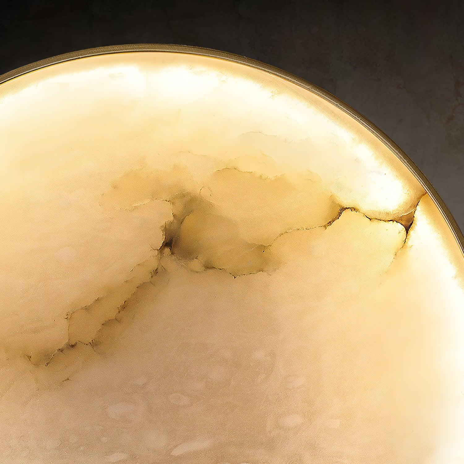 Close detail of the illuminated cloudy stone pattern and fine gold rim