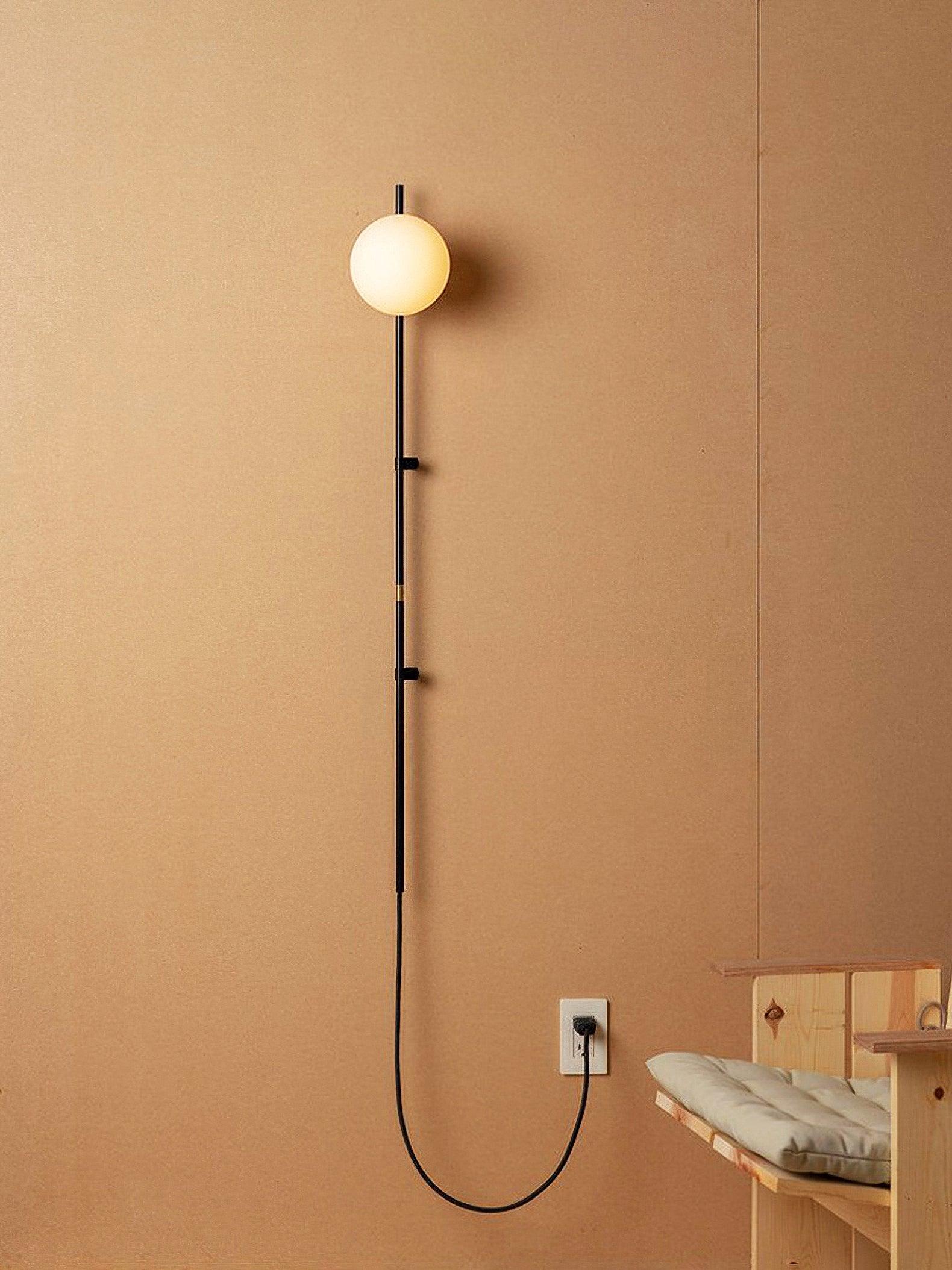 Long-stem globe lamp with a looped black cable