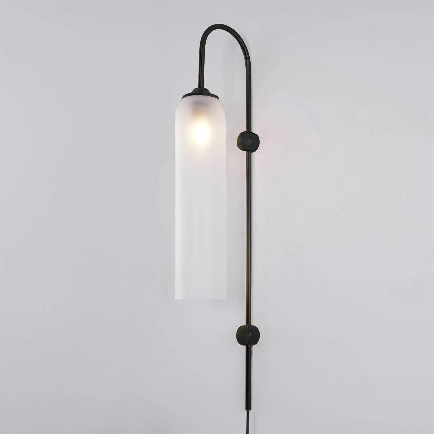 Frosted white tube shade on a black wall stem with a curved upper arm
