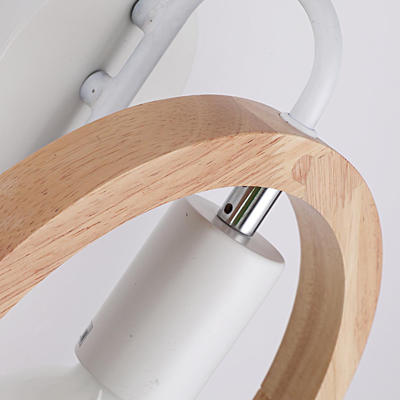 Detail of the wooden arch’s grain and joint, white curved bracket, silver-colored socket stem and cylindrical bulb holder