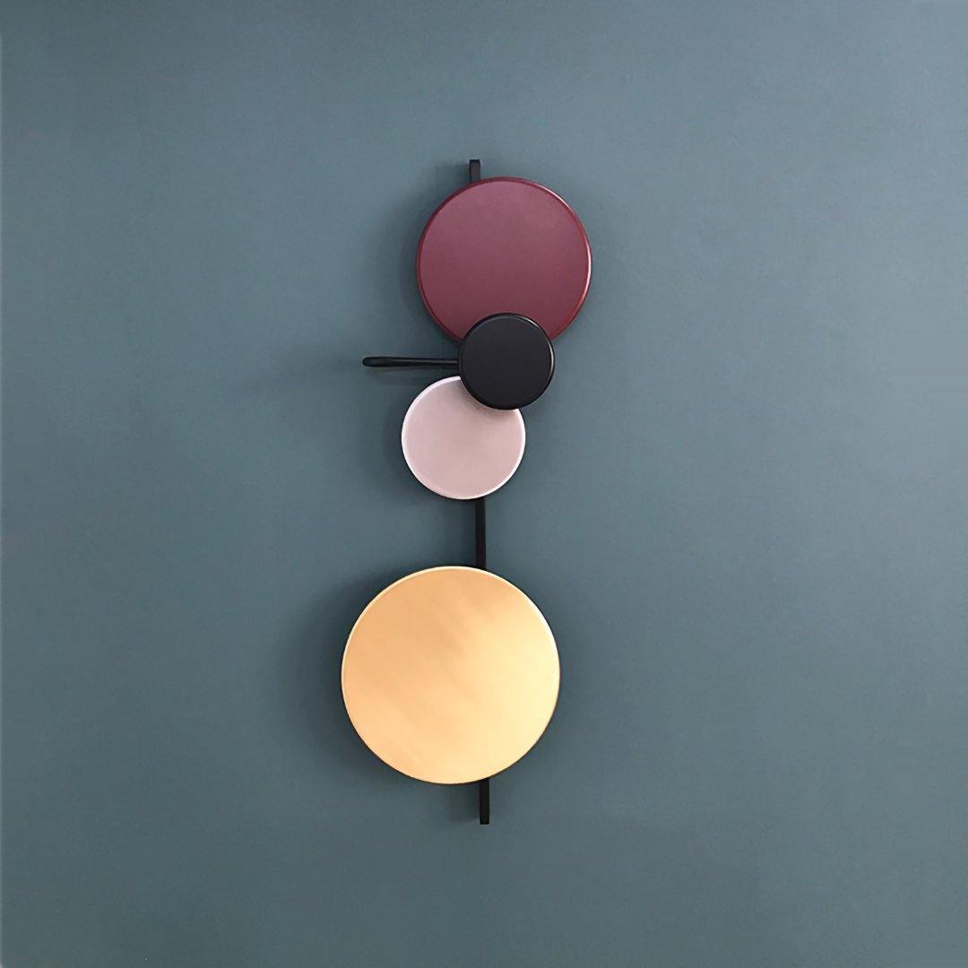 Plum disc fixture with contrasting circular surfaces