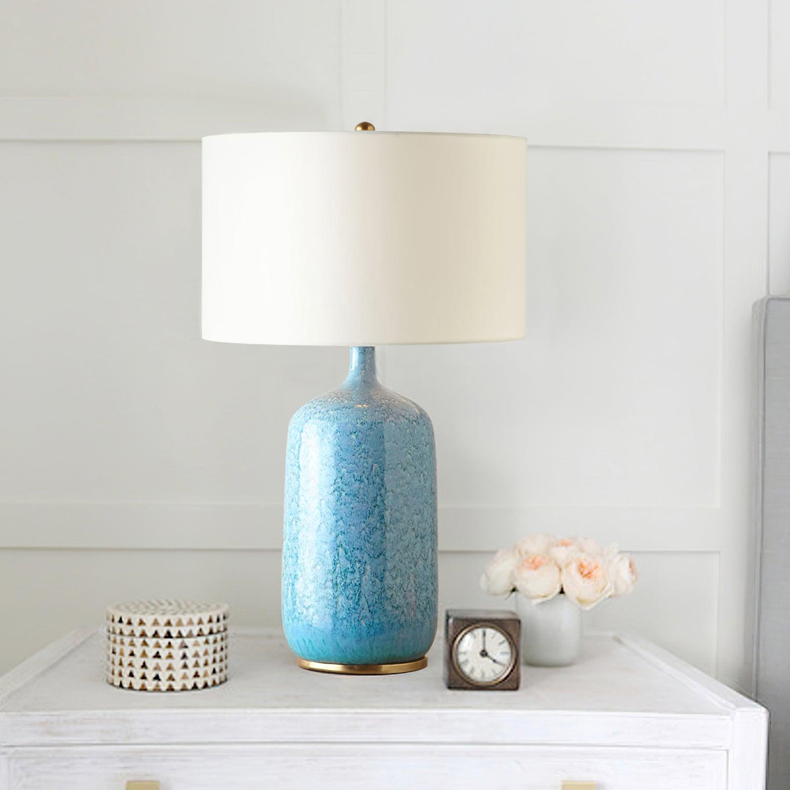 Culloden lamp on a white cabinet beside flowers and a clock