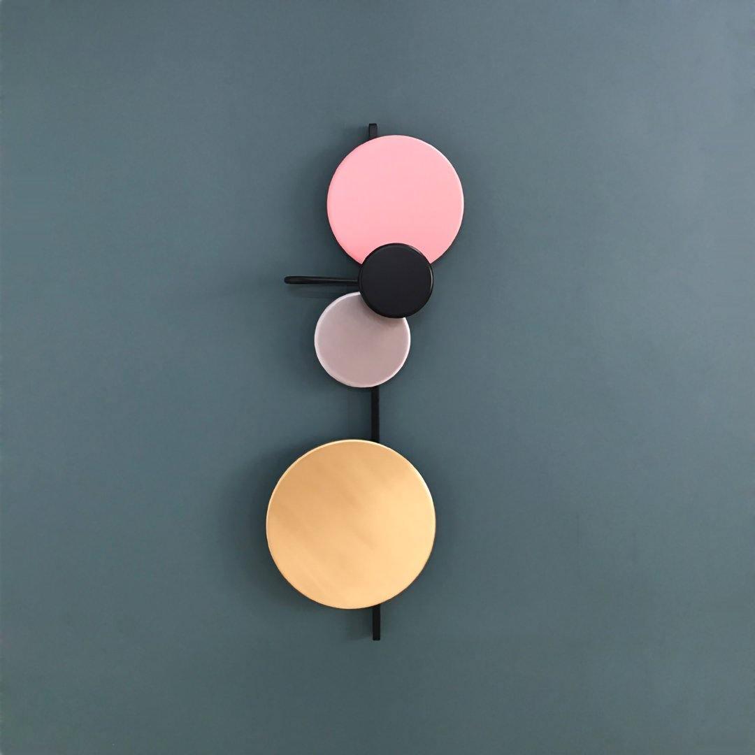 Pink upper disc on a blue-grey wall