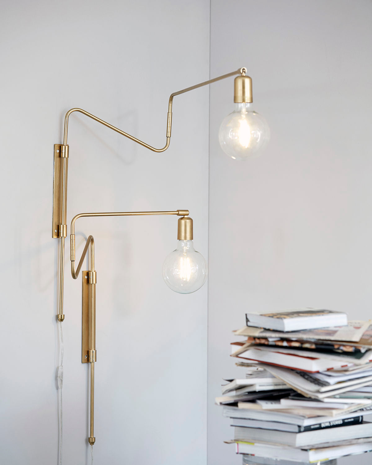 Two Brass Swing lamps with exposed bulbs