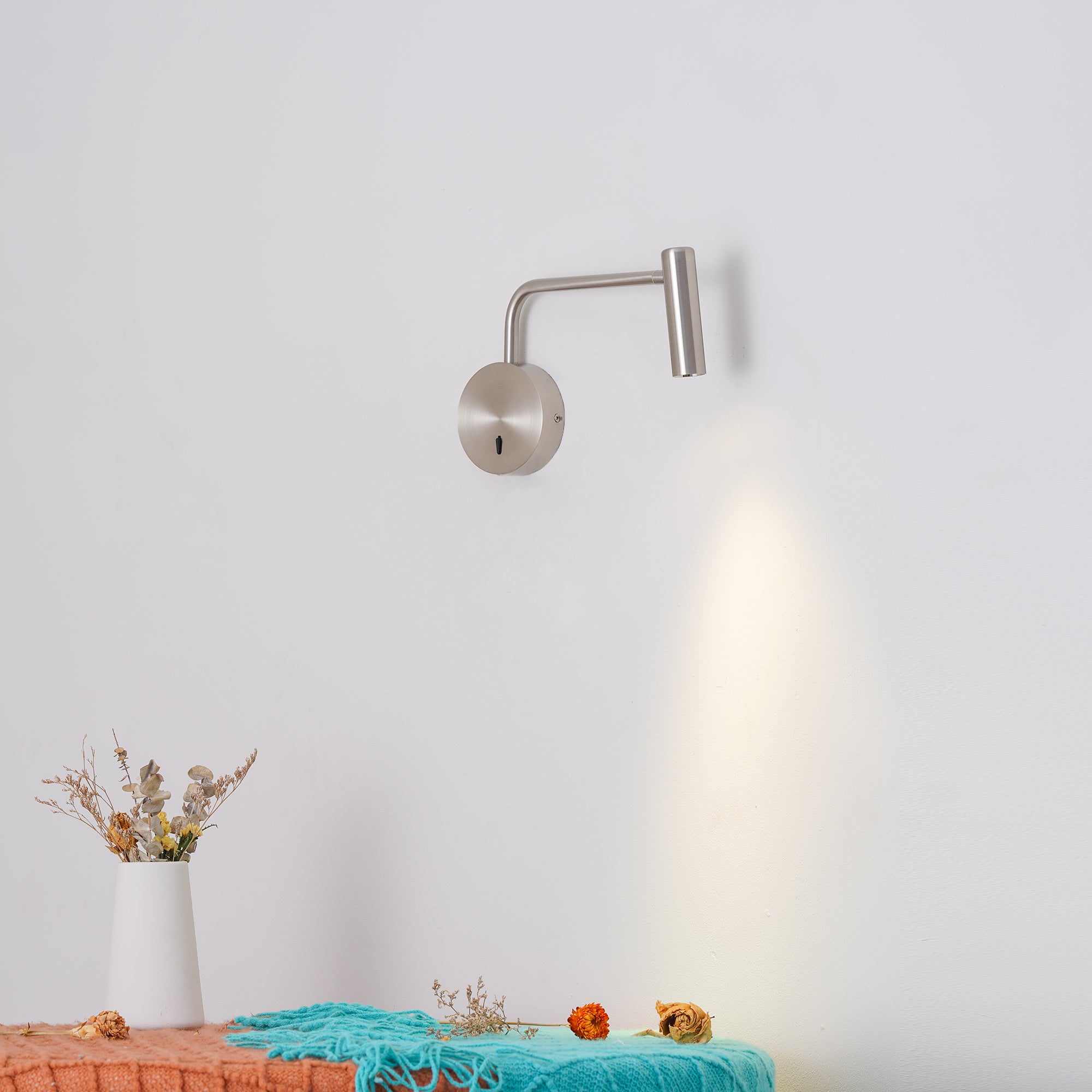 Cylindrical wall light shown casting a downward beam