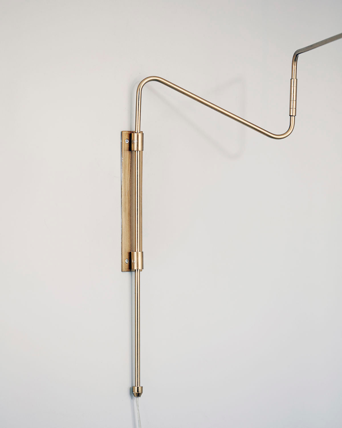 Brass wall-mounted Swing lamp in extended position