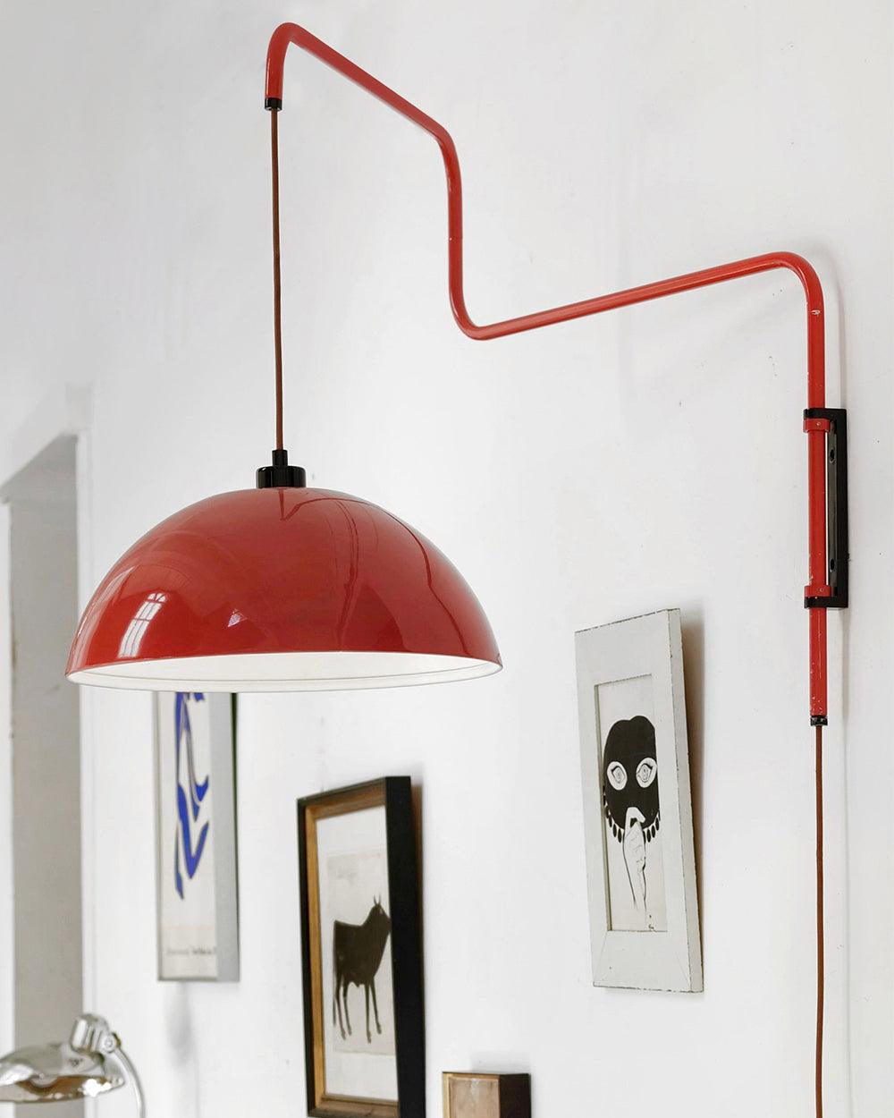 Long red wall fixture above framed pictures