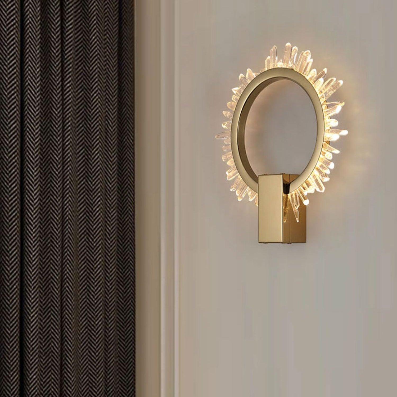 Angled crystal ring wall light beside black-and-white herringbone fabric and pale wall panels