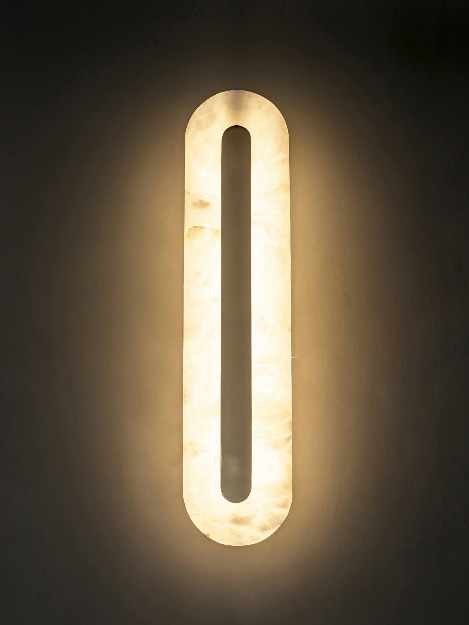 Backlit rounded stone outline on a dark wall