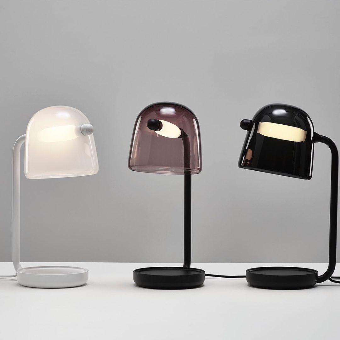 White, tinted-grey and dark Mona table lamps shown side by side