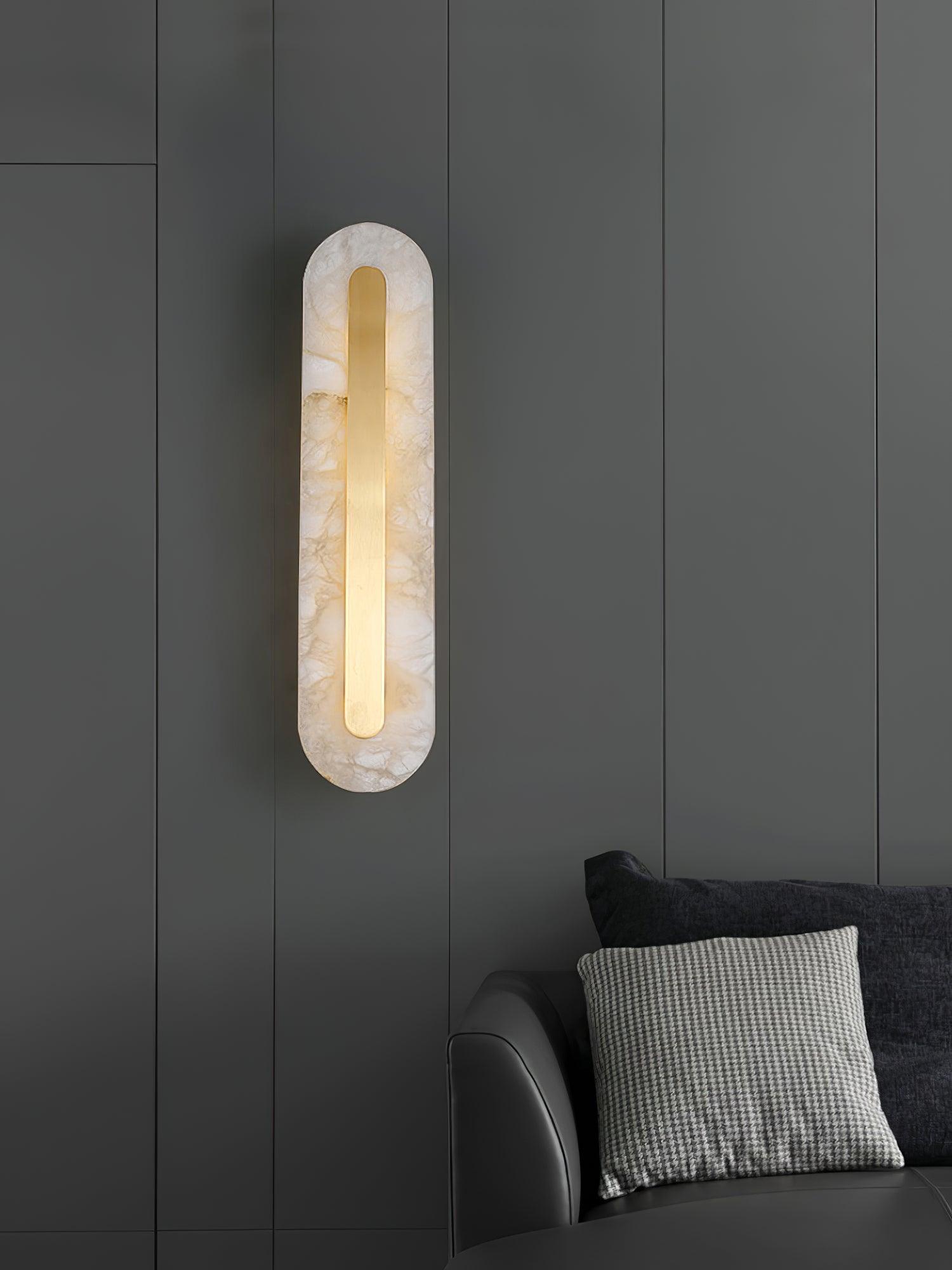 Vertical wall fixture above a dark sofa
