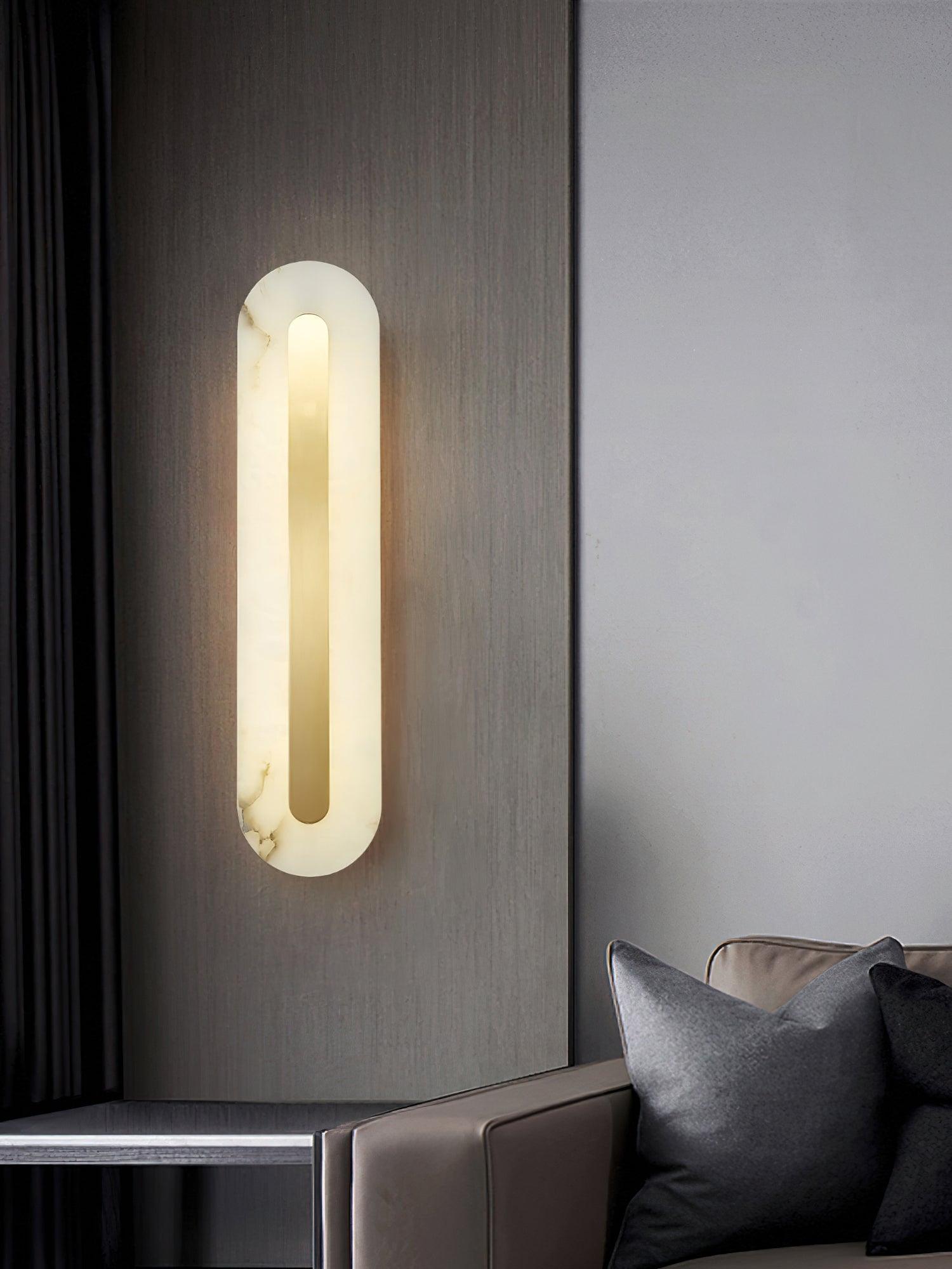 Illuminated alabaster panel near a dark sofa
