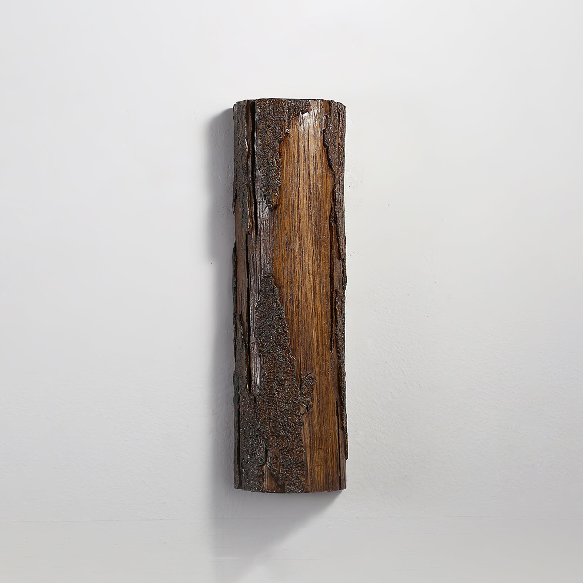 Unlit brown Broken Bark wall light on grey wall, showing grain-like streaks and raised dark relief
